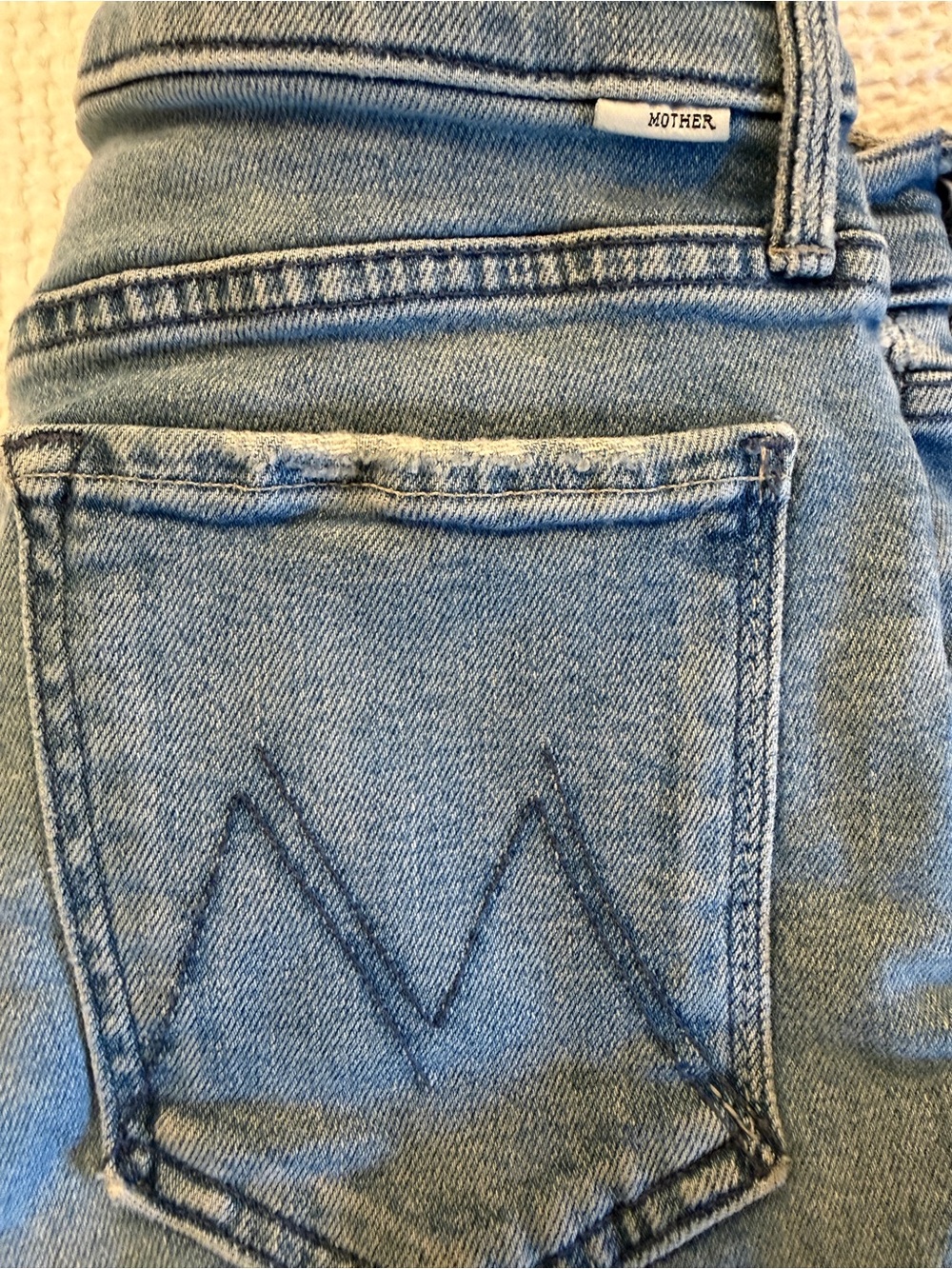 MOTHER TOMCAT Faded Light Blue High-Rise Jeans with Signature Pocket Stitching